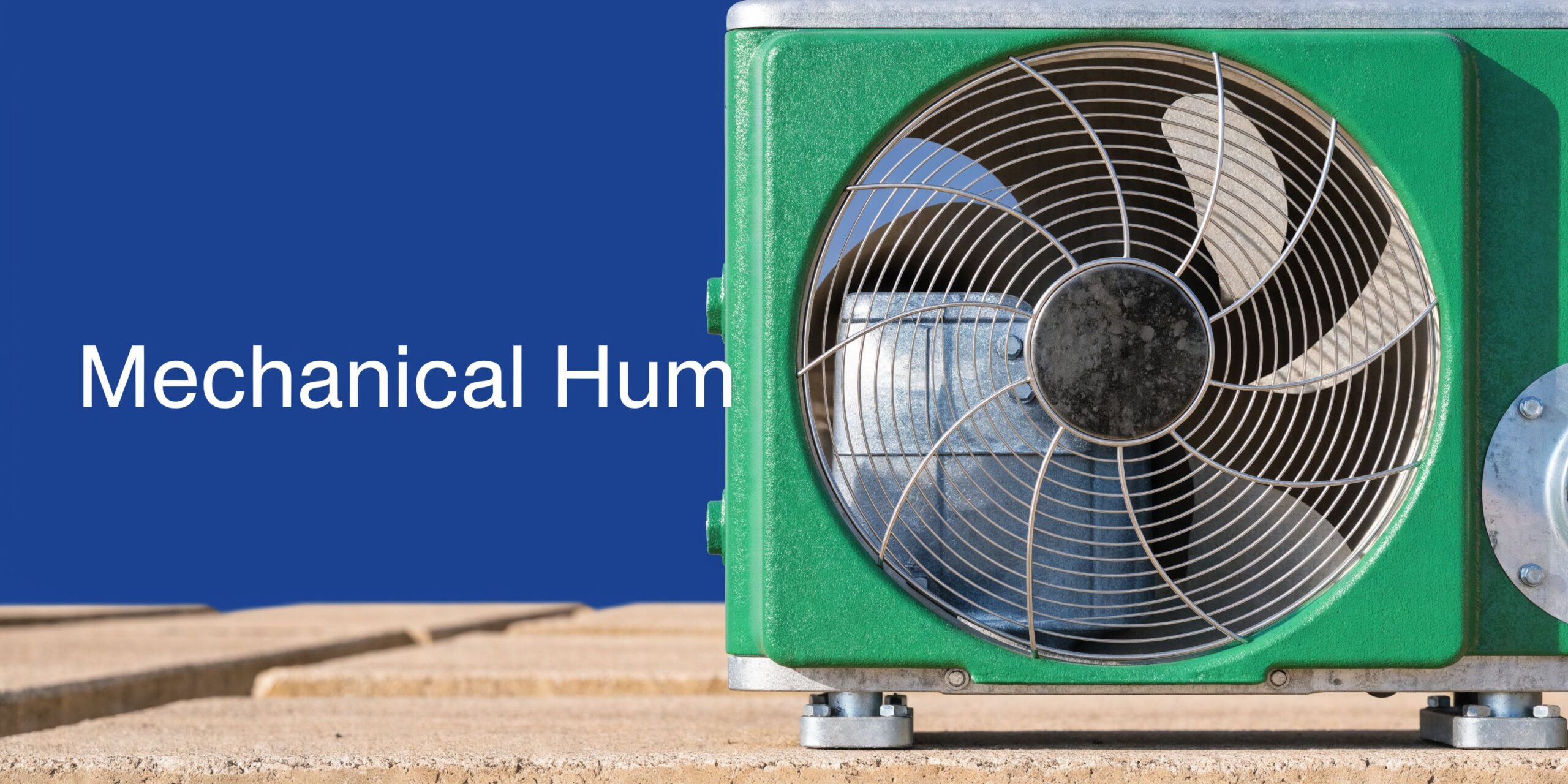 A close-up view of an outdoor air conditioning unit featuring a green housing and metal fan grill.