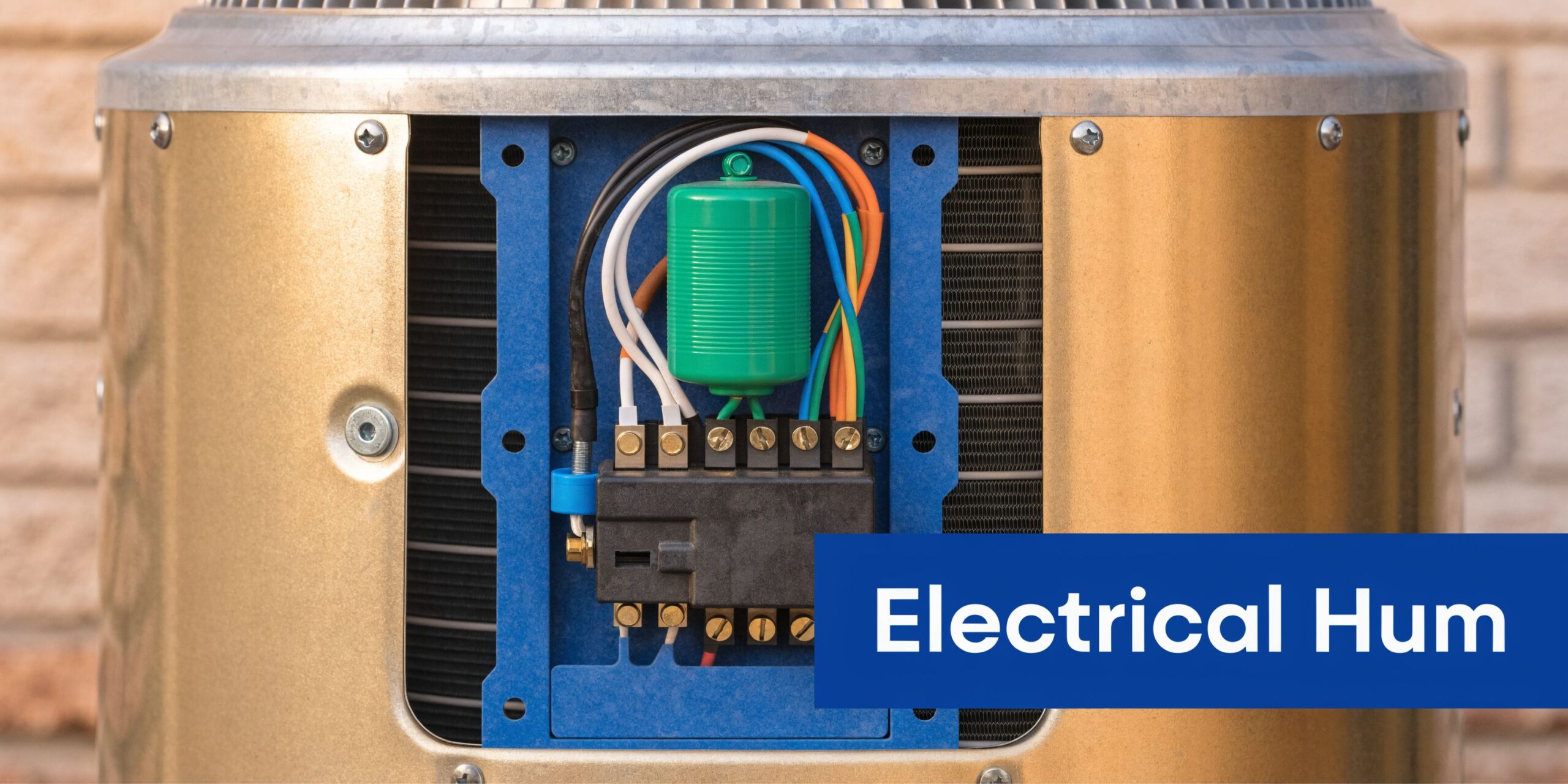 Close-up of the electrical wiring and capacitor inside an outdoor residential air conditioner unit component box.